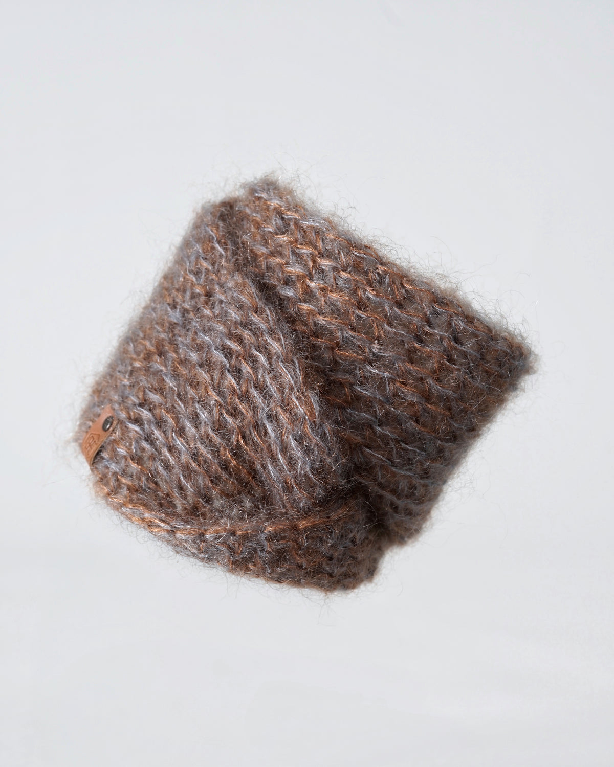 The blue brown melange mohair snood laid flat and folded, the two-tone yarn visible in the open knit