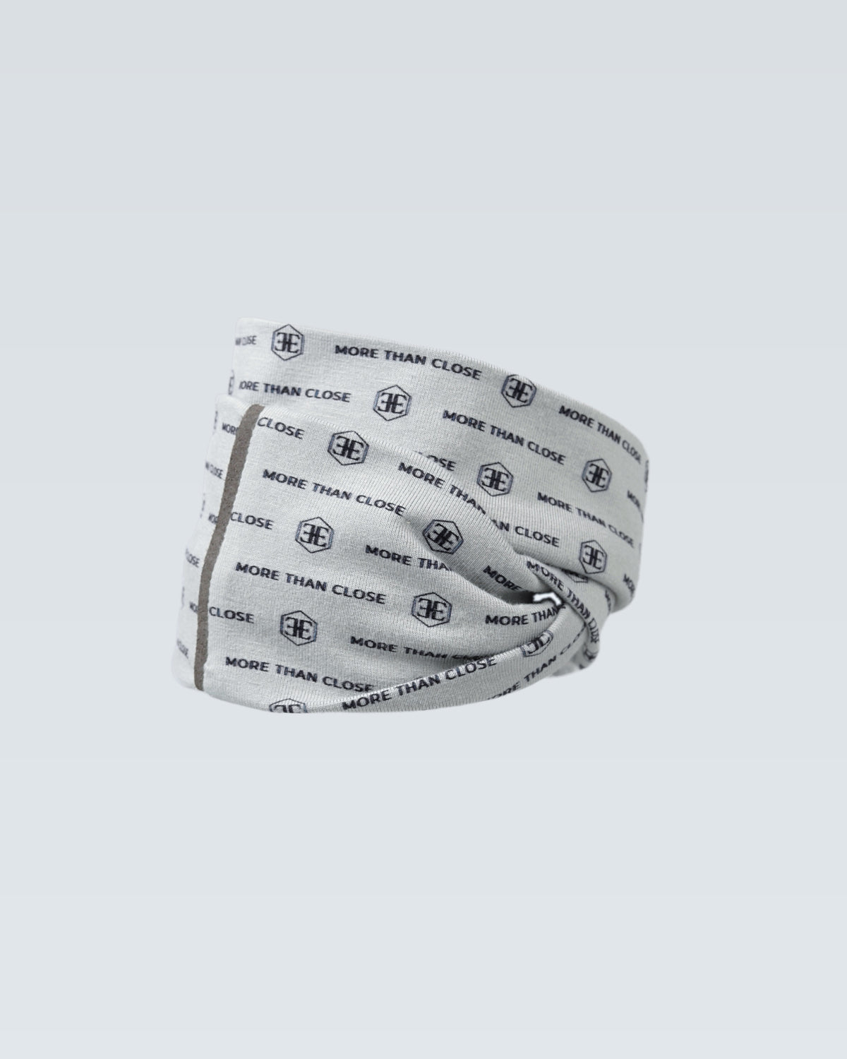 The light grey printed snood rolled into a band, a fine seam running down one side