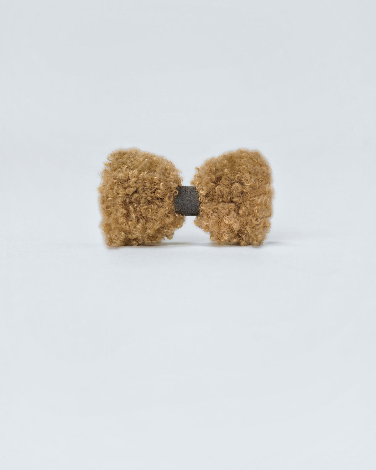 Camel bouclé bow with a grey faux-suede centre, front view