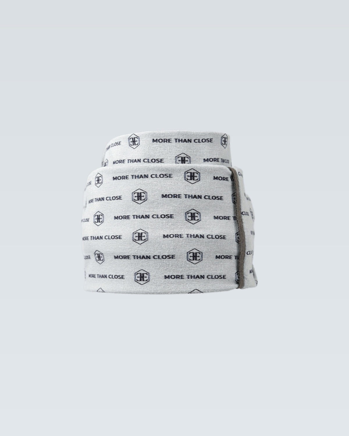 The light grey printed snood shown as an open tube, holding its shape without stiffness